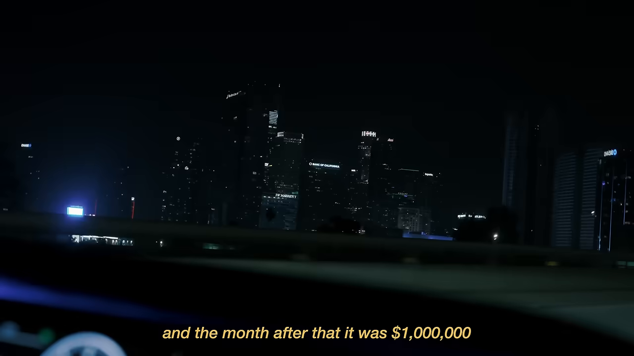 차 안 야경 위에 "and the month after that it was $1,000,000" 자막이 얹히는 순간 — 청구서 100만 달러 돌파를 알리는 화면